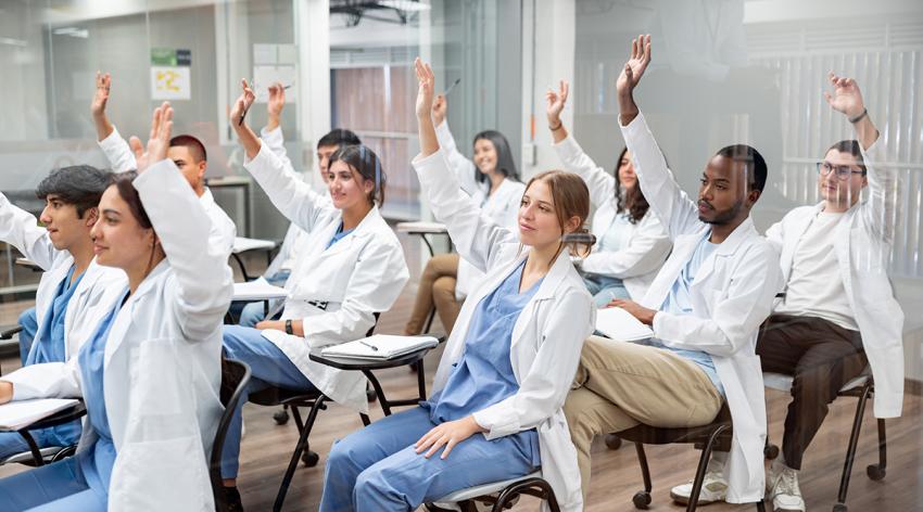 Medical students in the classroom raising their hands to ask questions