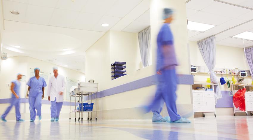 Blurred shot of doctors working in a busy hospital corridor