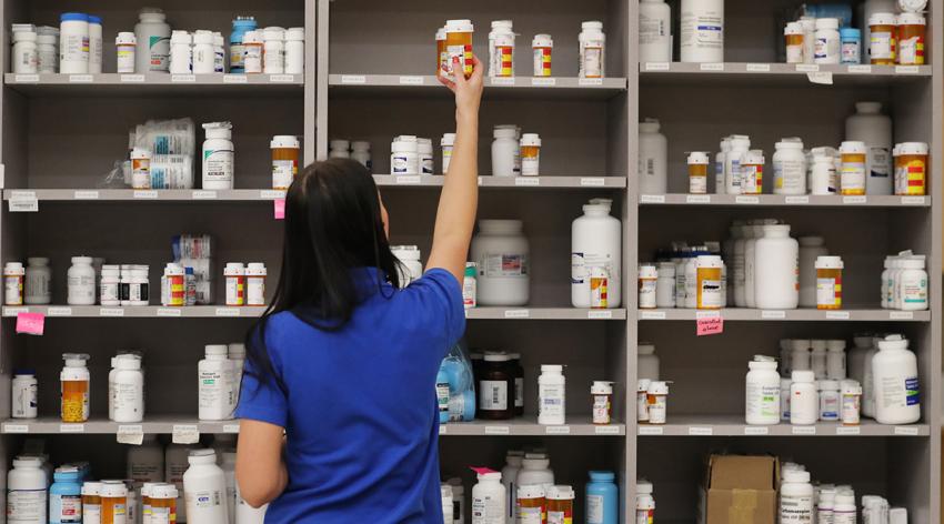 A pharmacy technician grabs a bottle of drugs off a shelf at the central pharmacy of Intermountain Heathcare on September 10, 2018 in Midvale, Utah.