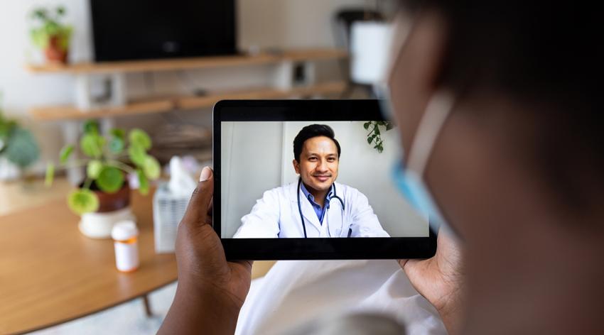 A patient talking to a physician using a tablet