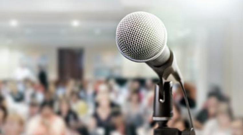 Microphone awaits public speaker at seminar or conference.