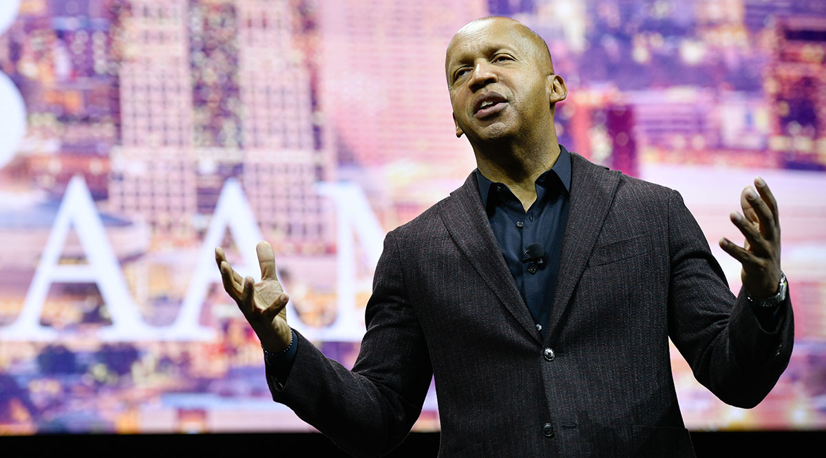 Civil rights attorney and author Bryan Stevenson delivers a speech on stage. 