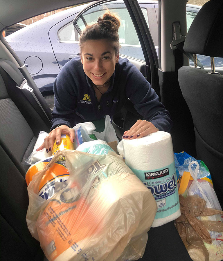 University of Michigan Medical School student Kenzie Corbin loads cleaning supplies for delivery to a clinic that cares for patients experiencing homelessness