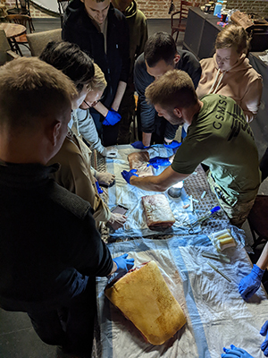 Aaron Epstein, MD, president of the Global Surgical and Medical Support Group, trains doctors in a bunker in Ukraine in March how to insert trauma chest tubes.