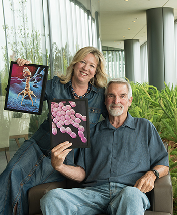 Steffanie Strathdee, PhD, and Tom Patterson, PhD, with photos of the life-saving phage and deadly bacterium.