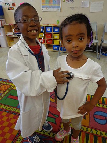 two kids acting as a doctor and a patient