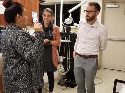 CHW Lidia Regino talks with resident Sarah Friedberg, MD, and attending physician David Armstrong, MD, at the One Hope clinic.