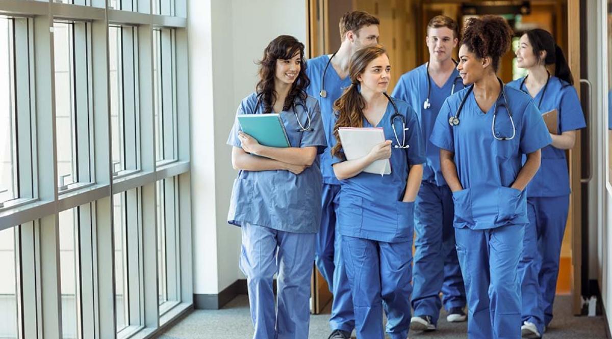 doctors in scrubs walking down a hallway
