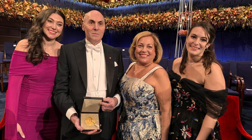 Drew Weissman, MD, PhD, displays his Nobel Prize medal after the ceremony in Stockholm, Sweden, flanked by (from left to right) his daughter Allison, wife Mary Ellen, PhD, and daughter Rachel.