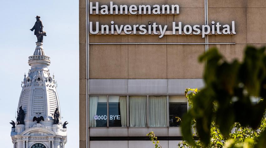 A photo taken July 15, 2019, of Hahnemann University Hospital and Philadelphia City Hall shows a small sign declaring "Goodbye".