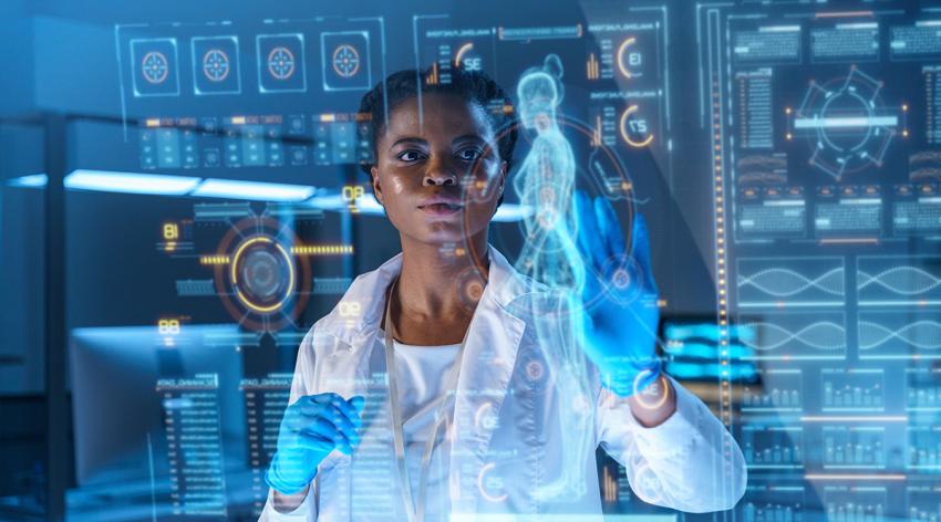 A young African-American doctor works on HUD or graphic display in front of her. We see her from the waist up in a modern laboratory.